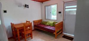a small bedroom with a bed and a window at Cabaña Claro de Luna in Merlo