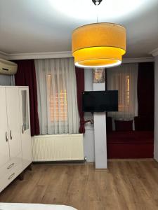 a living room with a television and a couch at Taksim Rain Suite in Istanbul