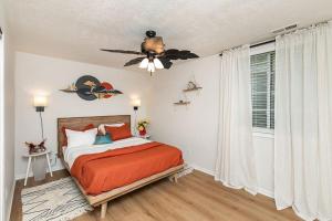 a bedroom with a bed and a ceiling fan at Family Friendly Home Close to Airport and Downtown in Des Moines
