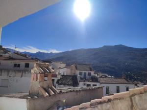 a view of a city from the roof of a building at La Noguera Rural Suite in Güéjar-Sierra