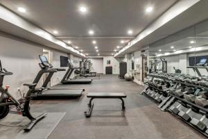a gym with treadmills and exercise equipment in a room at Life of the Party, Unit #418 in Nashville
