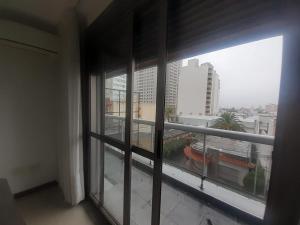 a window in a building with a view of a city at MC departamento in Río Cuarto