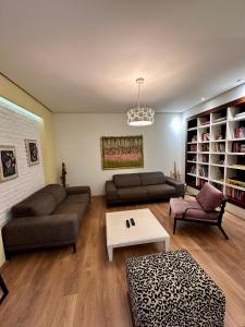 a living room with two couches and a coffee table at Center Apartment Easy in Tirana