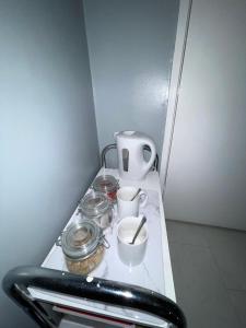 a counter with jars and a coffee maker on it at House near to CastleCourt shopping in Belfast