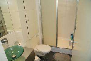 a bathroom with a toilet and a sink and a shower at SECC Ovo Apartments in Glasgow