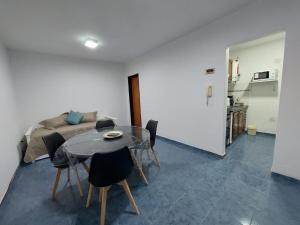 a living room with a table and a couch at Departamento Falucho 2 in Santa Rosa