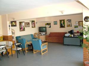 a living room with a couch and a table and chairs at Gultepe Apartments in Kusadası