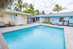 a swimming pool in front of a house at Siesta Key Beachside Villas in Sarasota