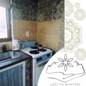 a small kitchen with a stove and a sink at Vidatierra in Potrerillos