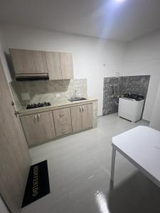 a kitchen with a sink and a table in a room at EDIFICIO BUENOS AIRES 1 Habitación in Sincelejo