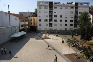 a courtyard with a basketball hoop in a city at Apartment Travego II in Osijek
