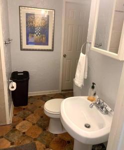 a bathroom with a white toilet and a sink at The House Hotels - Lark 2 in Lakewood