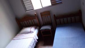 a small bedroom with two beds and a window at Hostel Sancris 2 in São José dos Campos