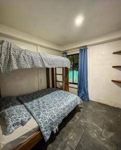a bedroom with a bunk bed and a window at Casitas Coloradas Puerto Viejo in Puerto Viejo