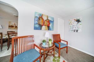 a living room with two chairs and a table at Cozy Euclid Apartment Near Downtown! in Euclid