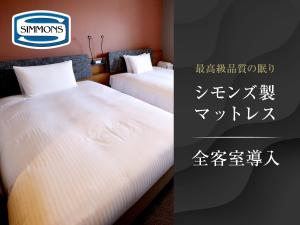 two beds in a hotel room with a sign on it at HOTEL SUI AKASAKA by ABEST in Tokyo