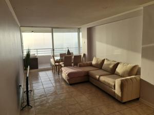 a living room with a couch and a table at Reñaca-Cochoa Vista Mar-3D -funicular directo playa in Viña del Mar