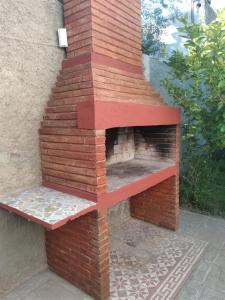 an outdoor pizza oven with a brick wall at Doña Wilma in San Rafael