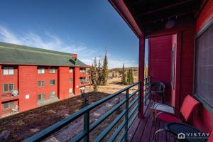 a balcony of a red building with a view at Giant Steps #43 W Hot Tub, Sauna, And Game Room! in Brian Head