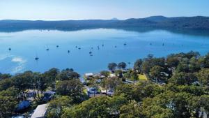 an aerial view of a lake with boats in it at Coastal Contentment in the Cove in North Arm Cove