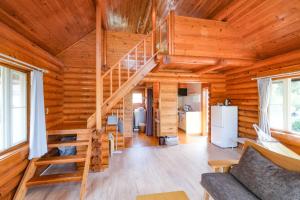 a log cabin with a spiral staircase in a living room at しまなみ宿sagi in Mukaitanoura