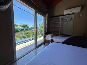 a bedroom with a bed and a large window at Dpto 2 dormitorios de Lujo in Bella Vista