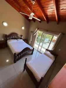 a bedroom with two beds and a large window at Dpto 2 dormitorios de Lujo in Bella Vista