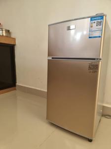 a stainless steel refrigerator sitting in a kitchen at Sibu Homestay Happy Family in Sibu