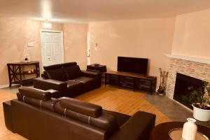 a living room with a couch and a fireplace at Ahava, Centropolis Laval in Laval