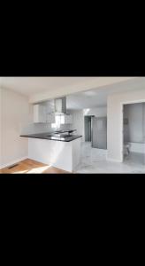 a white kitchen with a stove top oven at Cozy newly renovated house in Petersburg