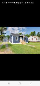 a blue house with a porch and a house at Cozy newly renovated house in Petersburg