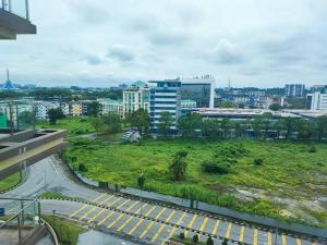 uma vista para uma cidade com um campo verde em The Foreigner Staycation at Riverine Diamond Kuching em Kuching