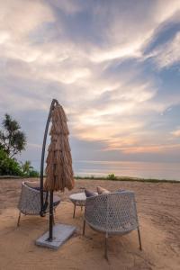 - deux chaises et un parasol sur la plage dans l'établissement Estella Phuket Mai Khao Beach Resort, à Mai Khao Beach 41 autres photos
