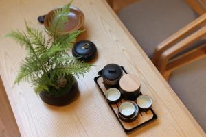 a wooden table with a potted plant on it at 北京悦明元星空白塔景观四合院民宿 in Beijing