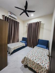 Katil atau katil-katil dalam bilik di Restu Villa Homestay