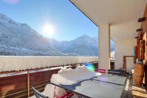 a balcony with a table and a view of mountains at Dents Du Midi 54, The Sunny Attic in Champéry