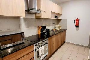 een keuken met een fornuis en een magnetron bij Nomad-In Luxury Suites and Apartments in Quito