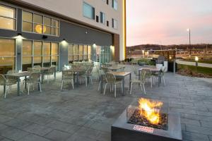 a patio with tables and chairs and a fire pit at Element North Kansas City in Kansas City