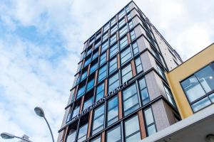 a tall building with a sign on the side of it at Hotel Grand Bach Kyoto Select in Kyoto