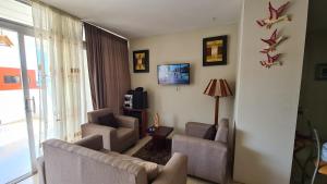 a living room with two couches and a tv at Amazing apartment in Salinas, Ecuador in Salinas