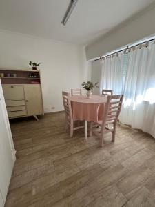 a dining room with a table and chairs at Neco Calle 16 in Necochea +3 photos