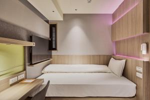 Katil atau katil-katil dalam bilik di Orange Hotel -Hanzhong, Taipei