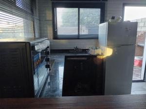 a kitchen with a white refrigerator and a counter at LOS ALTOS DE SAN JACINTO 2 in Mar del Plata