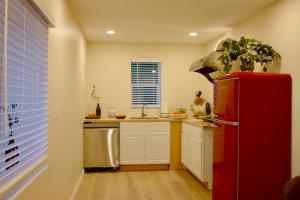 a kitchen with a red refrigerator and a sink at Hollywood Hills Haven-Guest House in Los Angeles