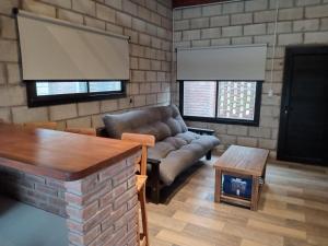 a living room with a couch and a table at LOS ALTOS DE SAN JACINTO 2 in Mar del Plata