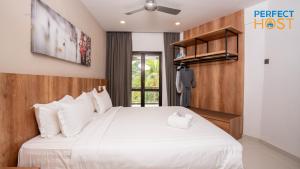 Ένα ή περισσότερα κρεβάτια σε δωμάτιο στο Damai Laut Escape by Perfect Host