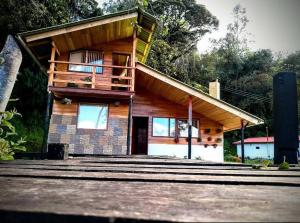 a house with a balcony on top of it at Killary, Laguna de La Cocha in Pasto