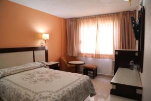 Postel nebo postele na pokoji v ubytování Hotel Baluarte