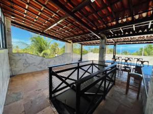 an outdoor dining area with a table and chairs at Apartamento na praia da tabuba com vista mar in Caucaia