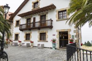a large white building with windows and balconies at Don Pablo in Pechón +77 photos